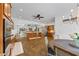 Open-concept kitchen with stainless steel appliances, wood cabinetry, and tile floors at 1005 Renfroe Lake Dr, Auburn, GA 30011