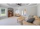 Living area features a tray ceiling, large windows, comfortable seating, and neutral tones at 1005 Renfroe Lake Dr, Auburn, GA 30011