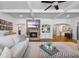 Cozy living room with stone fireplace, coffered ceilings, and open floor plan at 1005 Renfroe Lake Dr, Auburn, GA 30011