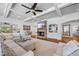 Bright living room featuring a stone fireplace and coffered ceilings at 1005 Renfroe Lake Dr, Auburn, GA 30011