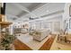 Open concept living room featuring coffered ceilings, hardwood floors, and a stone fireplace at 1005 Renfroe Lake Dr, Auburn, GA 30011