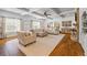 Large living room with coffered ceilings, fireplace, and hardwood floors at 1005 Renfroe Lake Dr, Auburn, GA 30011