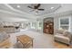 Spacious living room featuring neutral colors, plush carpeting, and abundant natural light at 1005 Renfroe Lake Dr, Auburn, GA 30011