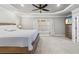 An elegant main bedroom with a tray ceiling, fan, and plenty of natural light at 1005 Renfroe Lake Dr, Auburn, GA 30011