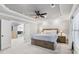 An elegant main bedroom with a tray ceiling, fan, and plenty of natural light at 1005 Renfroe Lake Dr, Auburn, GA 30011