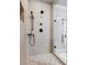 This shower showcases tile floors, a granite countertop and a framed mirror at 1005 Renfroe Lake Dr, Auburn, GA 30011