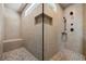 View of the tiled walk in shower featuring a built in bench and recessed shower products container at 1005 Renfroe Lake Dr, Auburn, GA 30011