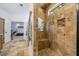 Travertine tiled shower with a built-in bench and decorative mosaic tile at 1005 Renfroe Lake Dr, Auburn, GA 30011