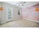 This bedroom has a door to outside and a unique paint design on the wall at 2801 Avington Se Ln, Smyrna, GA 30080