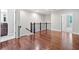 Upstairs hallway featuring hardwood floors, access to a bathroom, and view of an adjacent bedroom at 2801 Avington Se Ln, Smyrna, GA 30080