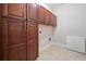Functional laundry room with dark wood cabinets and tile flooring at 2801 Avington Se Ln, Smyrna, GA 30080