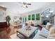 Open-concept living room and dining area featuring hardwood floors, a fireplace, and natural light at 2801 Avington Se Ln, Smyrna, GA 30080