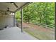 Back patio with ceiling fans, and view of fenced yard with mature trees at 2801 Avington Se Ln, Smyrna, GA 30080