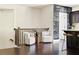 Hallway seating area with dark floors, accent chairs, stairway, and adjacent chalkboard wall leading into the kitchen at 2813 White Oak Ln, Decatur, GA 30032