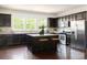 Spacious kitchen featuring a center island, dark cabinets, granite countertops, and stainless steel appliances at 2813 White Oak Ln, Decatur, GA 30032
