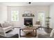 Cozy living room with a fireplace, hardwood floors, neutral decor, and plenty of natural light at 2813 White Oak Ln, Decatur, GA 30032