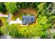 An aerial shot capturing a home surrounded by trees, manicured lawn, and a paved driveway at 5525 Belle Meade Dr, Villa Rica, GA 30180