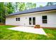 Home's beautiful back patio is the perfect spot for dining and outdoor entertaining, surrounded by a lush lawn at 5525 Belle Meade Dr, Villa Rica, GA 30180