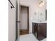 A vanity in bathroom with an open door to the bedroom at 5525 Belle Meade Dr, Villa Rica, GA 30180