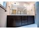Bathroom vanity with double sinks, dark wood cabinets, and a large framed mirror at 5525 Belle Meade Dr, Villa Rica, GA 30180