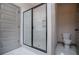Modern bathroom features a sleek glass shower with a toilet and white tile surround at 5525 Belle Meade Dr, Villa Rica, GA 30180