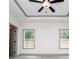 Bedroom with two windows, neutral carpet, and a ceiling fan at 5525 Belle Meade Dr, Villa Rica, GA 30180