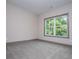 Bedroom with large window with view to trees and neutral colors, offering a calming retreat at 5525 Belle Meade Dr, Villa Rica, GA 30180