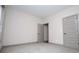 A neutral bedroom with gray carpet, trim, and a five-panel door at 5525 Belle Meade Dr, Villa Rica, GA 30180