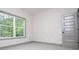 This bedroom features a window with natural light and neutral decor at 5525 Belle Meade Dr, Villa Rica, GA 30180