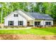 A beautiful exterior of a single-Gathering home featuring a front porch and a lush green lawn at 5525 Belle Meade Dr, Villa Rica, GA 30180