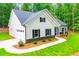 Inviting one-story home with attached garage, white siding, black shutters, and well-maintained front yard at 5525 Belle Meade Dr, Villa Rica, GA 30180