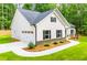 A well maintained new construction home exterior is shown with attached garage and landscaping at 5525 Belle Meade Dr, Villa Rica, GA 30180