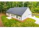Newly constructed home featuring a lush, green lawn, a white exterior, and a paved driveway and garage at 5525 Belle Meade Dr, Villa Rica, GA 30180