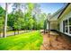 Exterior view of a house with lush green grass, trees, and a charming neighborhood at 5525 Belle Meade Dr, Villa Rica, GA 30180