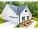 A well maintained new construction home exterior is shown with attached garage and landscaping at 5525 Belle Meade Dr, Villa Rica, GA 30180