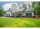 Beautiful one-story home with a white exterior, black shutters and large front yard at 5525 Belle Meade Dr, Villa Rica, GA 30180