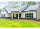 Beautiful one-story home with a white exterior, black shutters and large front yard at 5525 Belle Meade Dr, Villa Rica, GA 30180