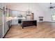 Spacious kitchen with granite counters, stainless appliances, light cabinetry and a fireplace in the living space at 5525 Belle Meade Dr, Villa Rica, GA 30180