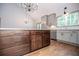 Modern kitchen with dark wood cabinets and stainless steel appliances under a vaulted ceiling with chandelier lighting at 5525 Belle Meade Dr, Villa Rica, GA 30180