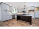 The gourmet kitchen featuring gray cabinets, stainless appliances, granite counters and a dark wood island at 5525 Belle Meade Dr, Villa Rica, GA 30180