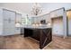 Bright kitchen featuring grey cabinets, a dark wood island, granite countertops, and stainless steel appliances at 5525 Belle Meade Dr, Villa Rica, GA 30180