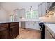 Bright kitchen with stainless appliances, white backsplash, and dark wood kitchen island at 5525 Belle Meade Dr, Villa Rica, GA 30180