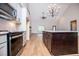 Open kitchen boasts stainless appliances, gray cabinetry, and a large dark island for food preparation and entertainment at 5525 Belle Meade Dr, Villa Rica, GA 30180