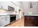 The gourmet kitchen with stainless steel appliances, light cabinetry, granite counters, and a dark island at 5525 Belle Meade Dr, Villa Rica, GA 30180