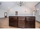 An open concept kitchen with a dark wood island, granite counters, lighting fixture and lots of storage at 5525 Belle Meade Dr, Villa Rica, GA 30180