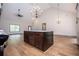 Open floor plan featuring a modern kitchen island with granite counters and wood floors at 5525 Belle Meade Dr, Villa Rica, GA 30180
