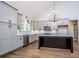 Gourmet kitchen featuring grey cabinetry, granite counters, stainless appliances and a dark wood kitchen island at 5525 Belle Meade Dr, Villa Rica, GA 30180