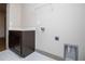Laundry room with dark cabinets and hookups at 5525 Belle Meade Dr, Villa Rica, GA 30180