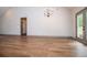 Spacious living room with beautiful hardwood flooring and access to the outdoor patio at 5525 Belle Meade Dr, Villa Rica, GA 30180
