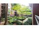 Community courtyard featuring manicured landscaping, stone walkways, and mature trees at 850 Piedmont Ne Ave # 1206, Atlanta, GA 30308